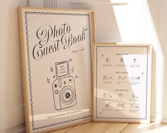 May include: Two framed signs with light wood frames. The larger sign says "Photo Guest Book" with a camera illustration and instructions. The smaller sign has photo instructions. The text "Help us remember this day forever!" is at the bottom.