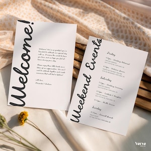 May include: Two white cards with black text. One says "Welcome!" and includes a message. The other says "Weekend Events" and lists a schedule. The cards are on a textured surface with a small yellow flower.