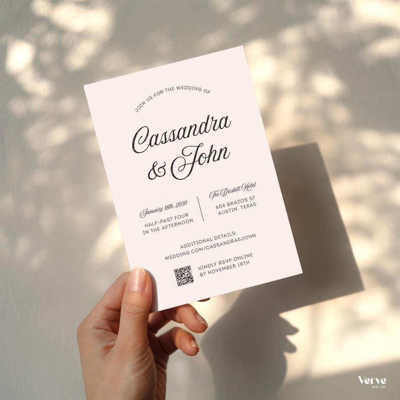 May include: A wedding invitation with the names Cassandra & John in elegant script. The invitation includes the date, time, and location: The Driskill Hotel in Austin, Texas. Additional details are available online. The invitation is held by a hand.