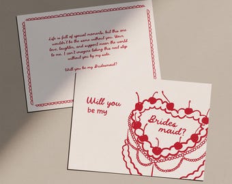 May include: Two white cards with red text and designs. One card has a scalloped border and reads "Life is full of special moments...Will you be my Bridesmaid?" The other card says "Will you be my Bridesmaid?" with a heart-shaped cake design.