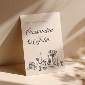 May include: A cream-colored wedding invitation with the text "Join us for the wedding of Cassandra & John." Below the text is a black line drawing of a cake, wine glasses, and a bottle.