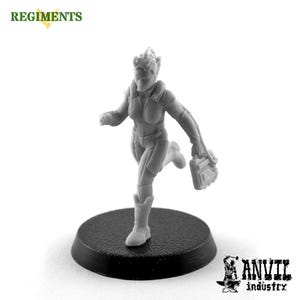 May include: A gray plastic miniature figure of a female character running with a device in her hand. The figure is standing on a black circular base.