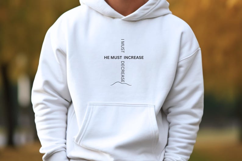 May include: White hoodie with a black graphic print that reads "I must decrease, He must increase".