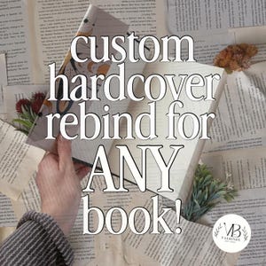 May include: A custom hardcover book rebinding service featuring a book with a celestial-themed cover design, surrounded by scattered vintage book pages, small dried floral accents, and a circular logo with the text VB VALBINDS EST 2024.