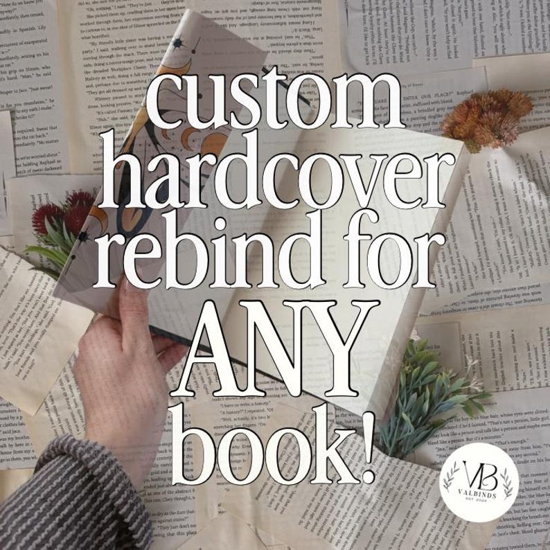 May include: A custom hardcover book rebinding service featuring a book with a celestial-themed cover design, surrounded by scattered vintage book pages, small dried floral accents, and a circular logo with the text VB VALBINDS EST 2024.