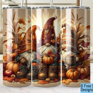 May include: Three fall-themed tumblers with gnomes wearing brown, red, and orange hats. Each gnome is holding a pumpkin, a fall leaf, and a mug. The tumblers are decorated with fall leaves, pumpkins, and corn stalks.