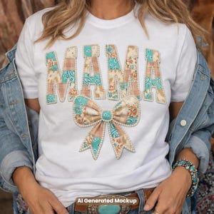 May include: A white short-sleeved t-shirt featuring the word MAMA in large block letters and a bow graphic below. The letters and bow are filled with a patchwork pattern of floral and paisley prints in shades of teal, peach, and tan, outlined with white beads.