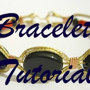 May include: A gold wire wrapped bracelet with black oval beads and red and black beads. The bracelet has the text "Bracelet Tutorial" on it.
