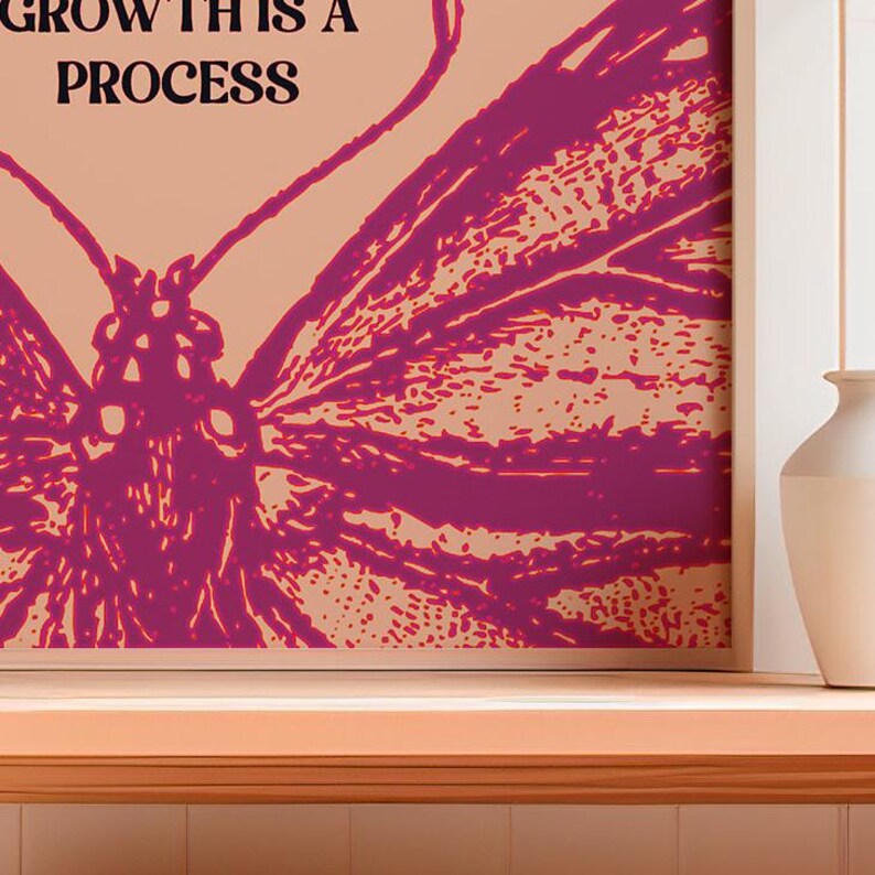 May include: A pink butterfly with a peach background and the text "GROWTH IS A PROCESS" in black.
