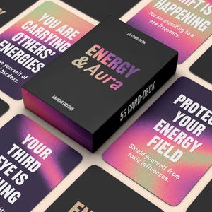 May include: A black box set of "Energy & Aura" 56 card-deck with a gradient pink and purple design. The cards feature phrases like "Protect Your Energy Field" and "Your Third Eye Is Opening". The box and cards have the text "ANDGARTISTORE".