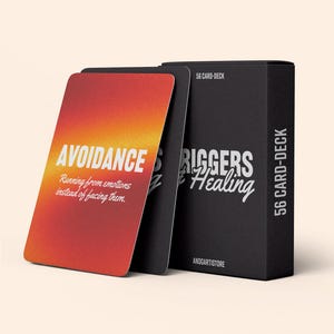 K&ouml;nnte beinhalten: Eine schwarze Box mit dem Text "56 Card Deck" und "Triggers & Healing" auf der Vorderseite. Die Box enth&auml;lt ein Kartenspiel mit einem roten, orangefarbenen und gelben Farbverlaufshintergrund und dem Text "Avoidance" und "Running from emotions instead of facing them".