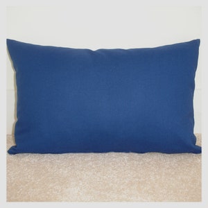 May include: A solid blue rectangular cushion with a smooth fabric surface.