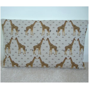 May include: A rectangular cushion with a beige linen fabric cover featuring a repeating pattern of brown and tan giraffes on a light grey background.