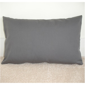 May include: A plain grey pillow with a rectangular shape. The pillow is made of a soft, smooth fabric.