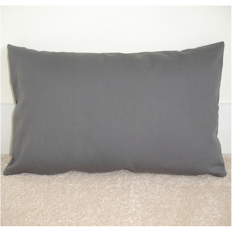 May include: A plain grey pillow with a rectangular shape. The pillow is made of a soft, smooth fabric.