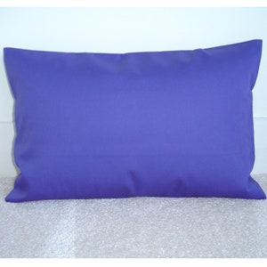 May include: A solid purple pillow with a rectangular shape. The pillow is made of a soft, smooth fabric.