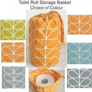 May include: Orange fabric toilet roll storage basket with a white leaf pattern. The basket has a drawstring closure and is shown with a toilet roll inside. Additional fabric swatches in green, orange, blue, and grey are also shown.