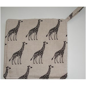 May include: A beige linen pot holder with a black and white giraffe print and a hanging loop.