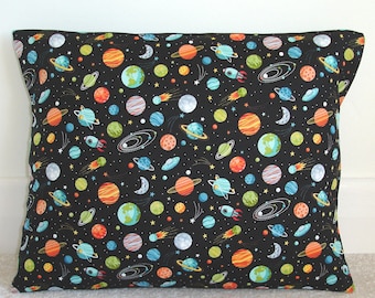 May include: A black pillowcase with a space-themed pattern. The pattern features planets, stars, rockets, and comets in various colours, including blue, green, orange, and red.