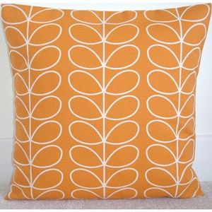 May include: Orange cushion with a white stylised leaf pattern.