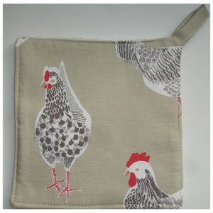 May include: A green fabric pot holder with a white and grey chicken design. The pot holder has a loop handle and is ideal for protecting your hands from hot dishes.