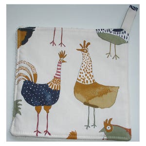 May include: A white cotton pot holder with a hanging loop. The pot holder features a colourful illustration of chickens and roosters with blue, red, yellow, brown, and green accents.