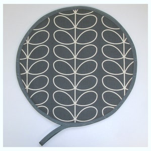May include: A round grey pot holder with a white stem pattern. The pot holder has a long handle.