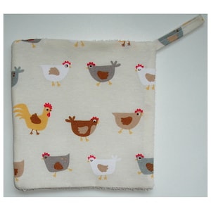May include: A white cotton kitchen towel with a hanging loop. The towel features a repeating pattern of brown, grey, and white chickens.