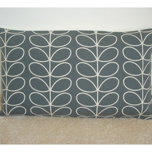 May include: A gray rectangular pillow with a white stylized leaf pattern.