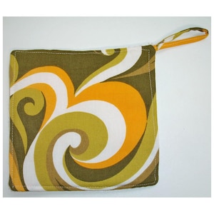 May include: Square pot holder with a loop, featuring a retro design. The fabric displays a swirling pattern in olive green, orange, white, and brown. The edges are stitched with white thread, and the loop is made from the same patterned fabric.
