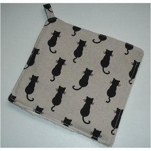 May include: A beige cotton pot holder with a black cat silhouette pattern. The pot holder has a loop for hanging.