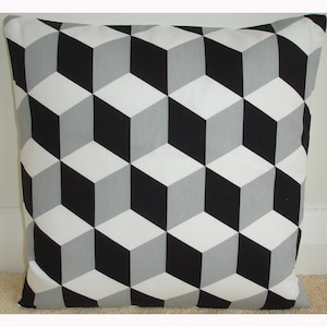 May include: Black, white, and gray geometric pattern cushion cover. The pattern features a repeating design of 3D cubes.