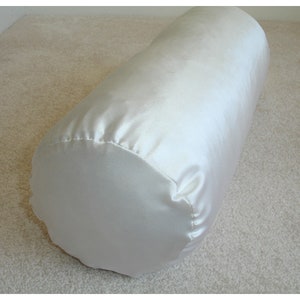 May include: A white satin cylindrical pillow, perfect for adding a touch of elegance to any room.