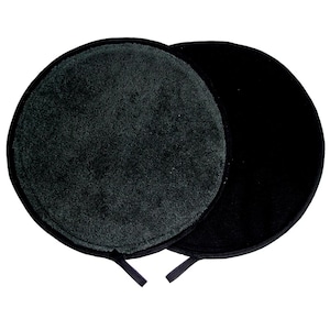 May include: Two black, circular, reusable makeup remover pads. One pad has a textured, dark grey surface, while the other is smooth and black. Each pad has a small black loop attached for hanging or storage.