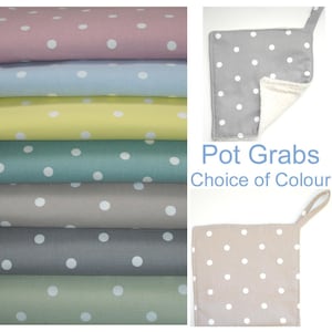 May include: Set of six pot holders with a white polka dot pattern on a variety of colours, including pink, blue, yellow, green, grey, and beige.  The pot holders have a loop for hanging.  Pot Grabs Choice of Colour.