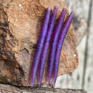 May include: Four purple and blue glitter fishing lures.