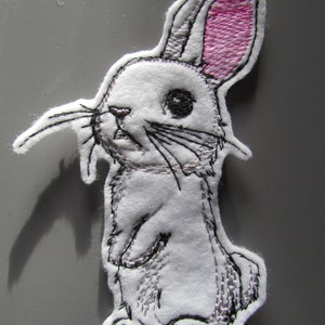May include: White embroidered bunny rabbit patch with pink ears. The bunny is standing on its hind legs with its front paws raised.