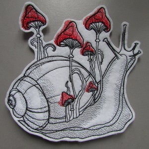 May include: Embroidered patch depicting a snail with a shell and a cluster of red mushrooms growing on its back.