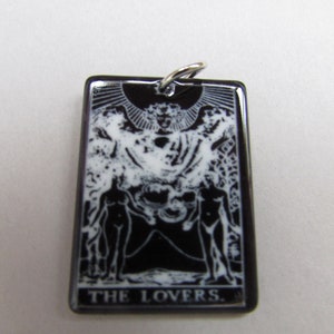 May include: Black and white tarot card pendant featuring the Lovers card image and the text "THE LOVERS."