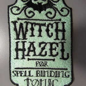 May include: A green embroidered patch with a black bat and the text "Witch Hazel for Spell Binding Tonic".