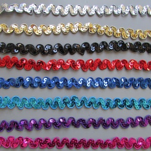 May include: Assortment of 10 rows of wavy, sequined trim in various colors, including silver, gold, black, red, blue, teal, purple, and pink.