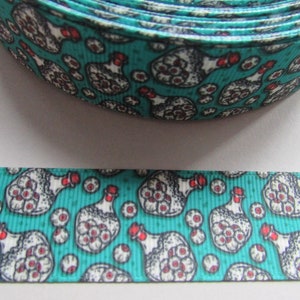 May include: Teal ribbon with a repeating pattern of white bottles filled with eyeballs and red lids. The bottles are surrounded by smaller white eyeballs.