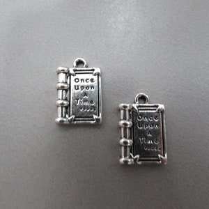 May include: Two silver-toned book charms with the words "Once Upon A Time" engraved on them.