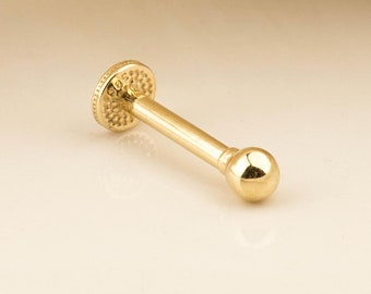 May include: A gold nose stud with a small ball on the end. The stud is made of 14k gold and is 6mm in length.