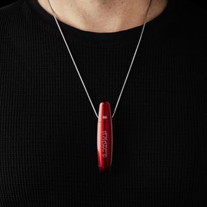 May include: A red metal pendant necklace with the word "AMAZE" engraved on it.