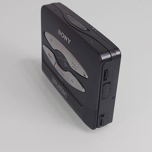 May include: Black Sony Walkman cassette player with silver buttons. The device has the word "SONY" printed on the top and "WALKMAN" on the bottom. The buttons include "FF", "REW", "FUNCTION", "REPEAT", and "BATT".