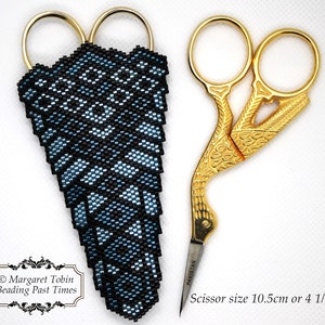 May include: A blue and black beaded scissor case with a gold pair of scissors. The scissors are 4 1/4 inches long and have a decorative design. The text "PAKISTAN" is printed on the scissors. The text "© Margaret Tobin Beading Past Times" is printed below the scissor case.