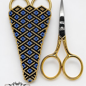 May include: A pair of gold-toned metal scissors measuring 4 1/4 inches alongside a triangular beaded sheath featuring a black, blue, and gold geometric diamond pattern. The text Margaret Tobin Beading Past Times is visible in the corner.