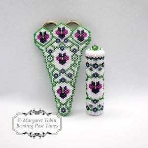 May include: A pair of beaded scissor sheaths and a beaded thimble, both with a white background and green and purple floral designs. The text "© Margaret Tobin Beading Past Times" is at the bottom of the image.