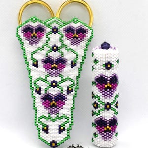 May include: A pair of white beaded scissor holders with a floral design featuring purple and pink pansies. The holders are attached to a pair of gold scissors. A white beaded tube with a similar floral design is also shown. The text "Margaret Tobin Beading Past Times" is at the bottom of the image.